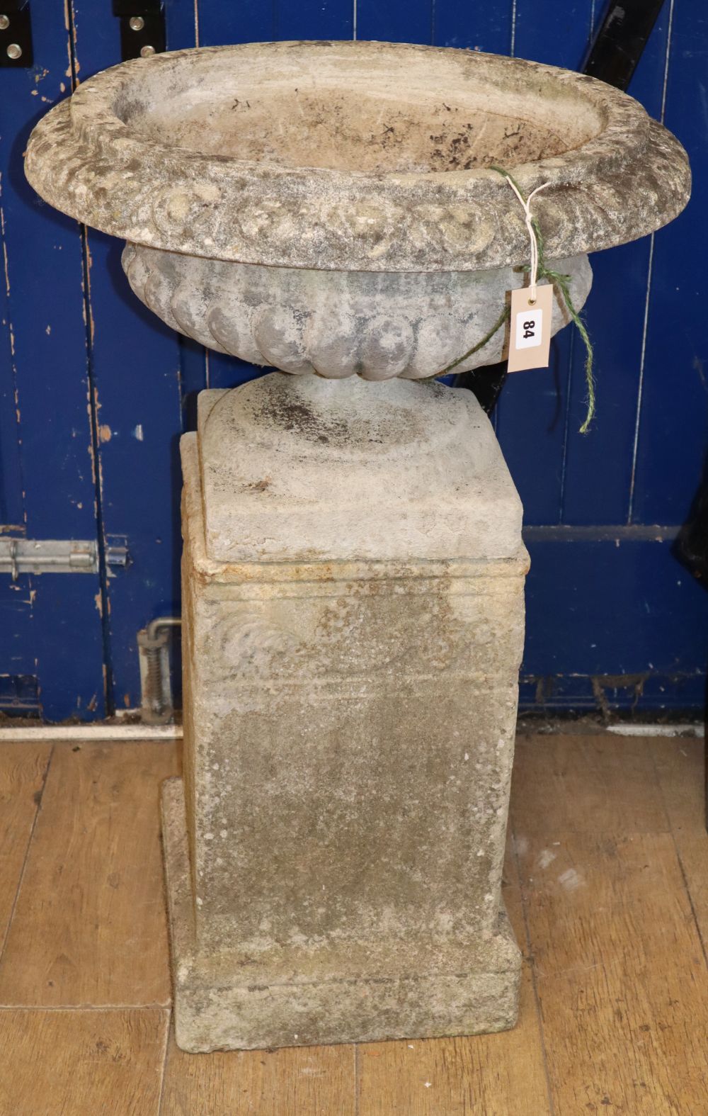 A reconstituted stone Campana garden urn on square-shaped plinth, H.94cm
